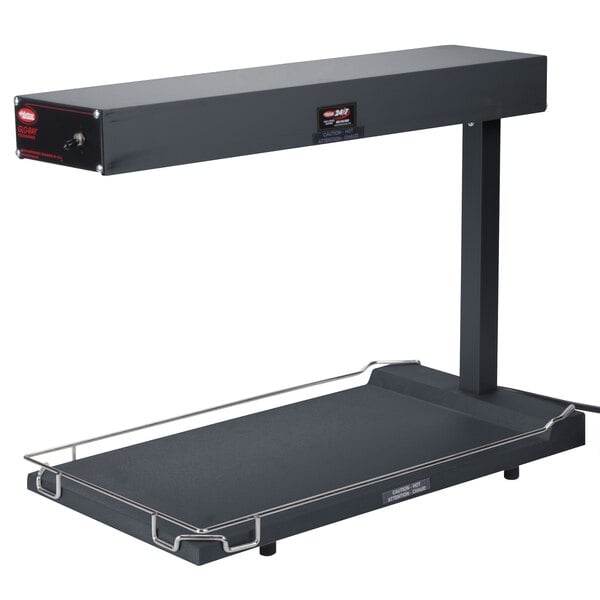 A gray rectangular Hatco portable food warmer with a metal frame on a table.