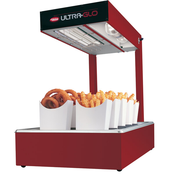 A red Hatco Ultra-Glo food warmer with french fries in a white container.