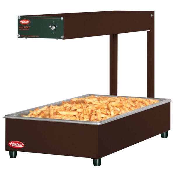 A Hatco Glo-Ray portable food warmer with french fries in a large rectangular container.