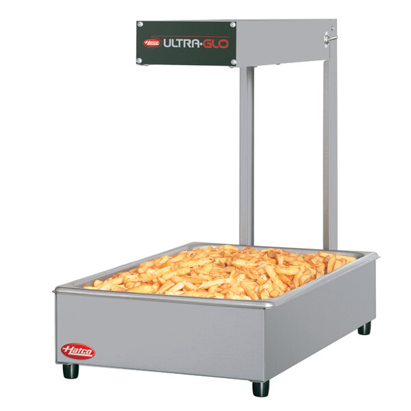 A large rectangular white Hatco food warmer with french fries inside.