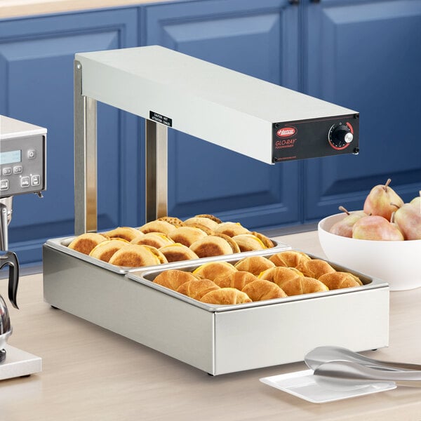 A Hatco Glo-Ray food warmer with a tray of food on a counter.