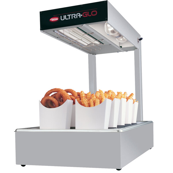 A Hatco Ultra-Glo white portable food warmer over a tray of french fries and onion rings.