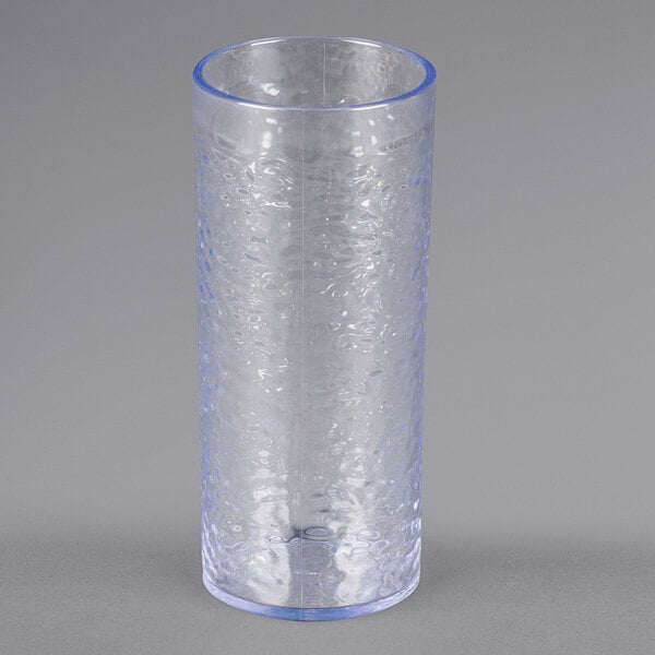 A clear Carlisle plastic tumbler with a blue rim.