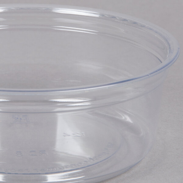 A Fabri-Kal clear plastic deli container with a clear lid on a white surface.