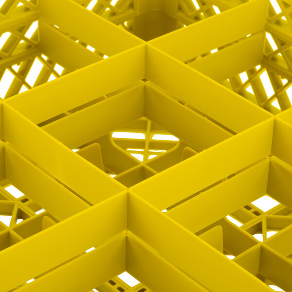 A yellow Vollrath Traex glass rack with square compartments.