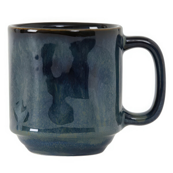 A Tuxton Yukon china mug with a dark blue handle and a black rim.