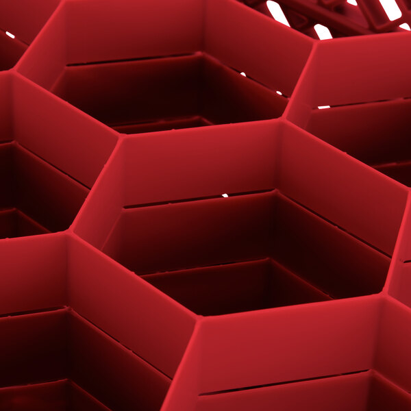 A red Vollrath Traex glass rack with hexagonal compartments.