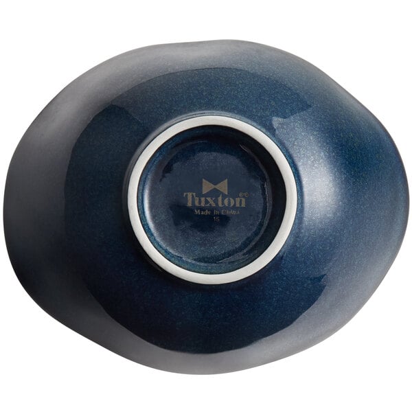 A Tuxton TuxTrendz Capistrano bowl with a blue interior and white rim.