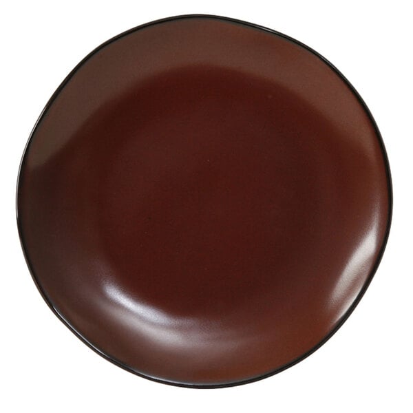 A brown Tuxton Artisan china plate with a black rim.