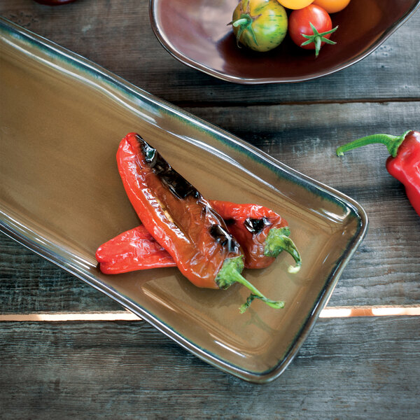 A TuxTrendz china tray with food including tomatoes and peppers on it.
