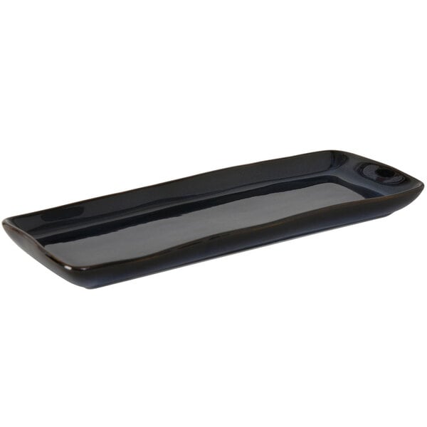 A black rectangular Tuxton china tray with a long handle.