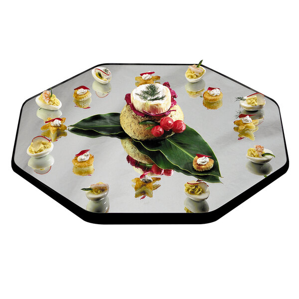 A Geneva octagon mirror food display tray with food on it.