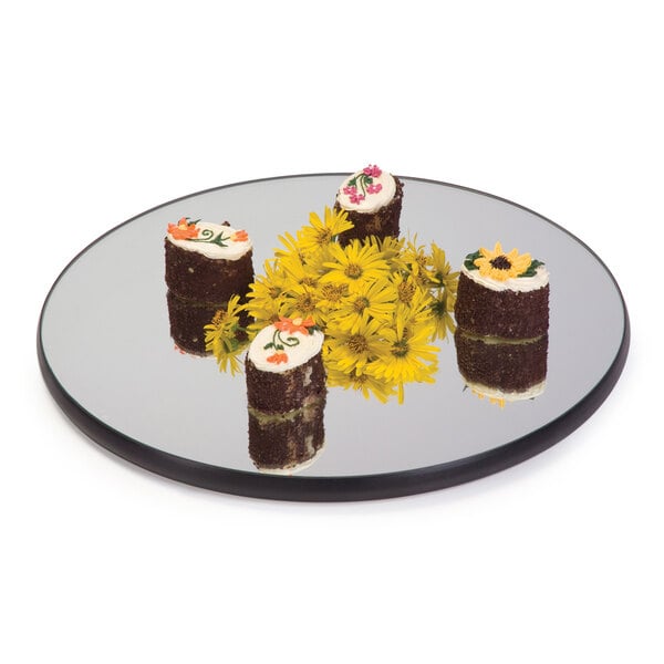 A Geneva round mirror tray with food on it.