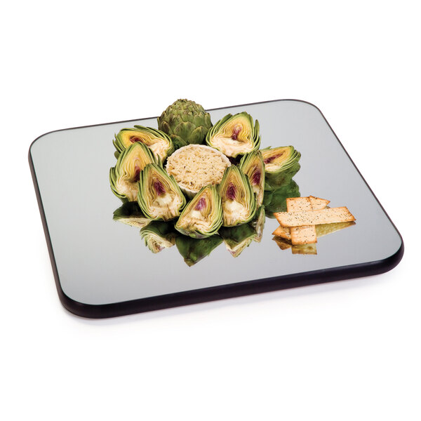 A Geneva square rimless mirror tray with food on it.