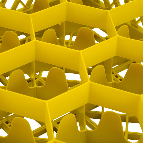 A yellow plastic Vollrath TR18J glass rack with 12 compartments and many holes.