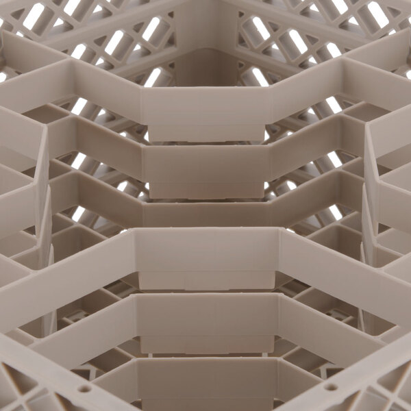 A close up of a beige Vollrath Traex rack with 12 compartments.