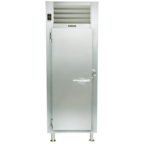 A Traulsen stainless steel single section pass-through refrigerator with a door open.