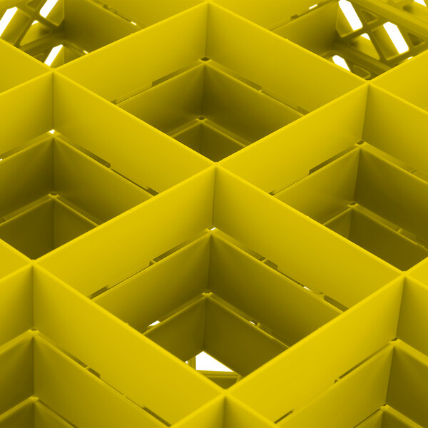 A yellow Vollrath Traex glass rack with square compartments.
