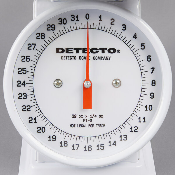 A white Cardinal Detecto portion scale with black text and a red hand.