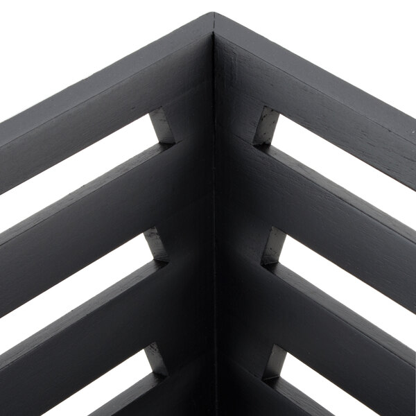 A black square tapered birch bread basket with holes.