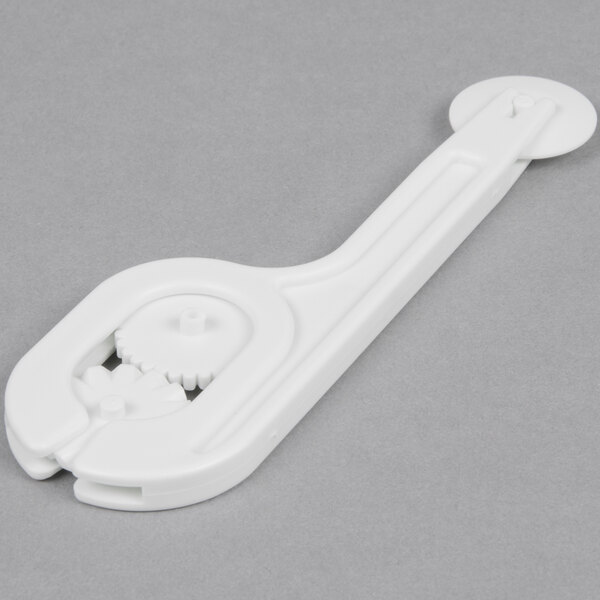 A white plastic Ateco fondant cutter with interchangeable wheels.