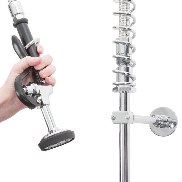 A hand holding a hose with a metal pipe and handlebar.