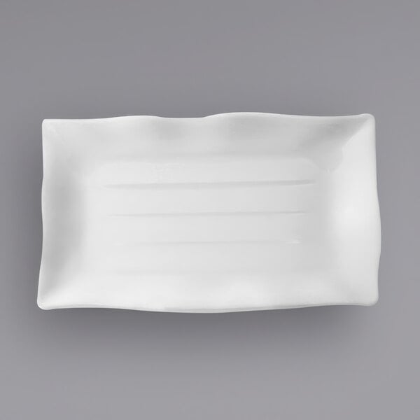 A white rectangular Thunder Group melamine plate with wavy edges.