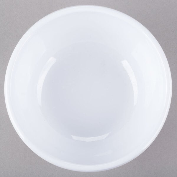 A white Thunder Group melamine bowl on a gray surface.