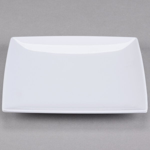 A close up of a white Thunder Group square melamine plate with a small rim.