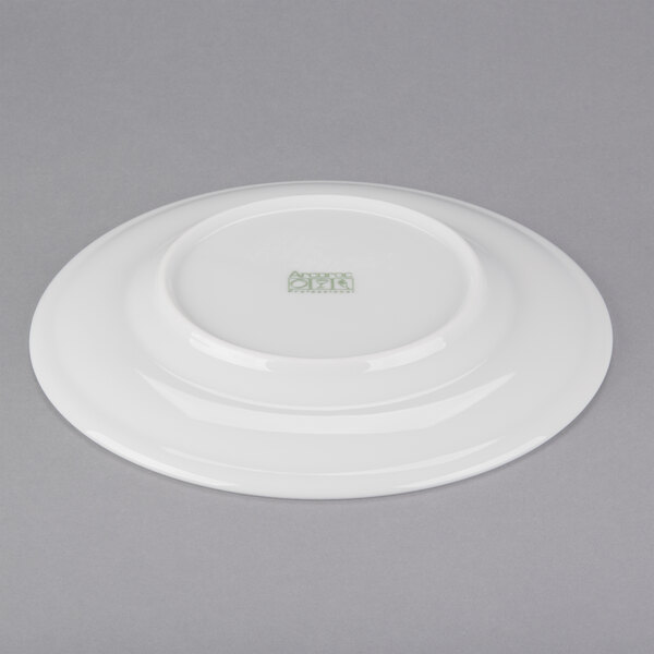 A white Arcoroc porcelain plate with a green logo.