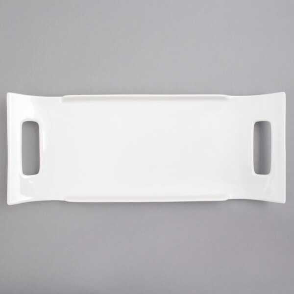 A white rectangular porcelain platter with two handles.