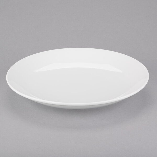An Arcoroc white porcelain plate with a rim.
