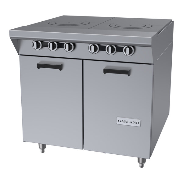 A stainless steel commercial range with two hot tops, six control knobs, and a double-door storage base.