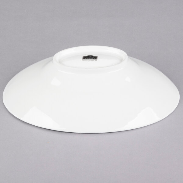 A white 10 Strawberry Street Whittier shallow oval porcelain bowl on a gray surface.