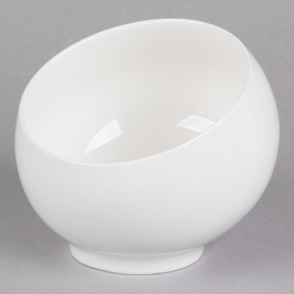 A 10 Strawberry Street Whittier white porcelain angled bowl on a gray surface.