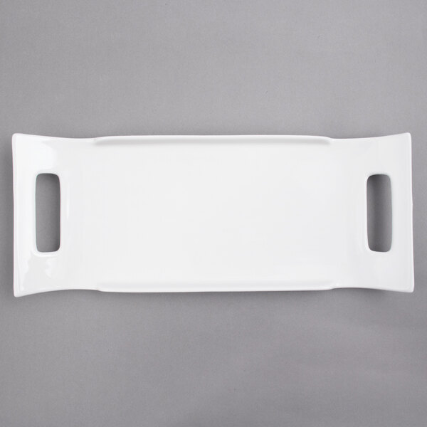 A white rectangular porcelain platter with two handles.