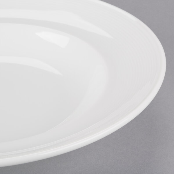 An Arcoroc white rim soup/pasta bowl.