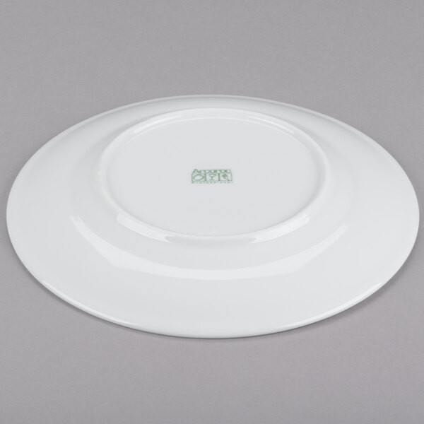 A white Arcoroc brunch plate with a green Arc Cardinal logo.