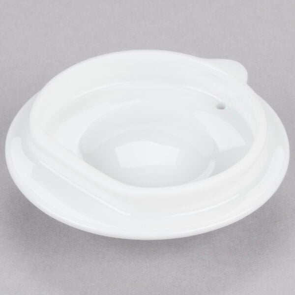 A white Arcoroc teapot with a lid.