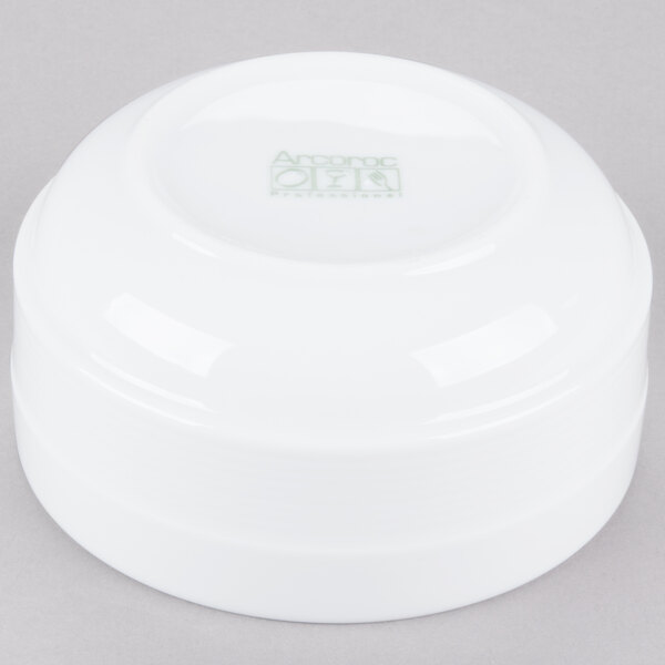 A white bowl with a logo reading "Arcoroc" in green.