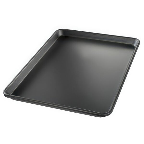 A Chicago Metallic BAKALON black aluminum sheet pan on a white counter.