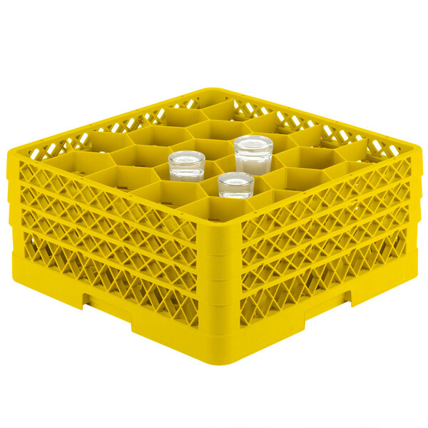 A Vollrath yellow plastic rack with glasses inside.