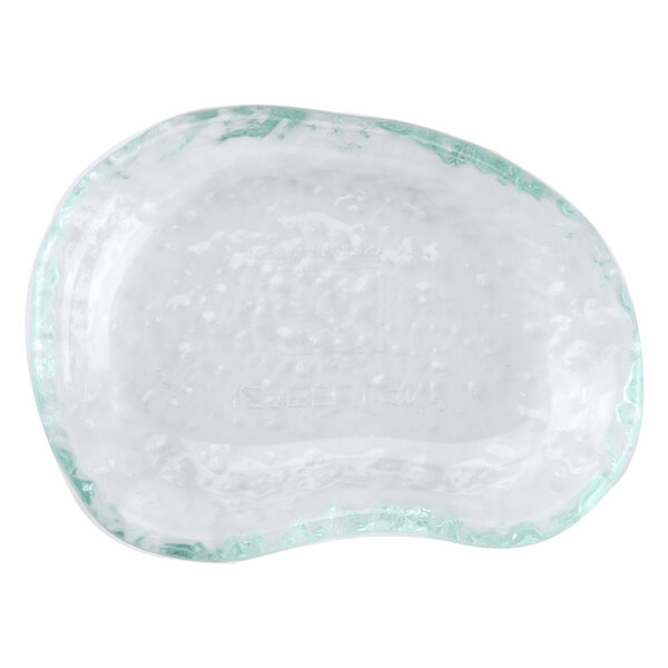 A clear glass dish with a white surface and green border.