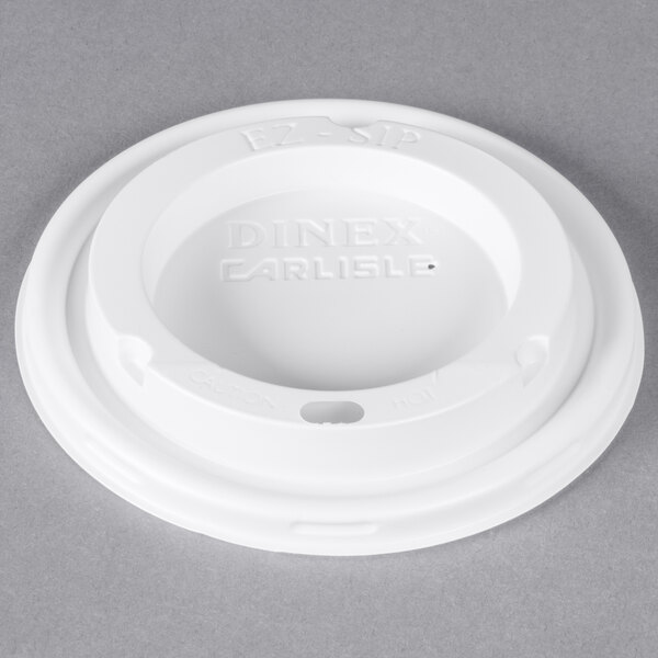A white plastic Dinex lid with text on it.