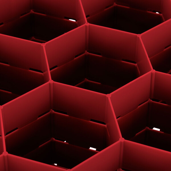 A red Vollrath Traex rack with hexagon compartments.