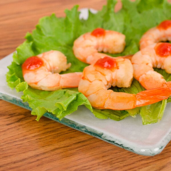 A plate of shrimp with tomato sauce on a 10 Strawberry Street Izabel Lam opal glass plate.