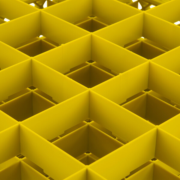A yellow Vollrath Traex glass rack with 25 square compartments.