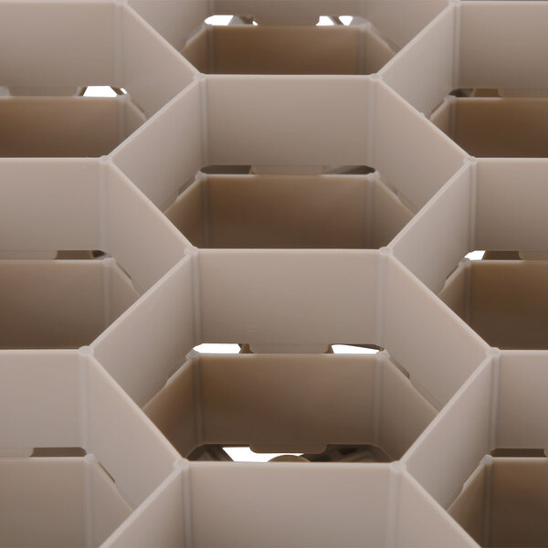 A close up of a beige plastic grid with a white surface