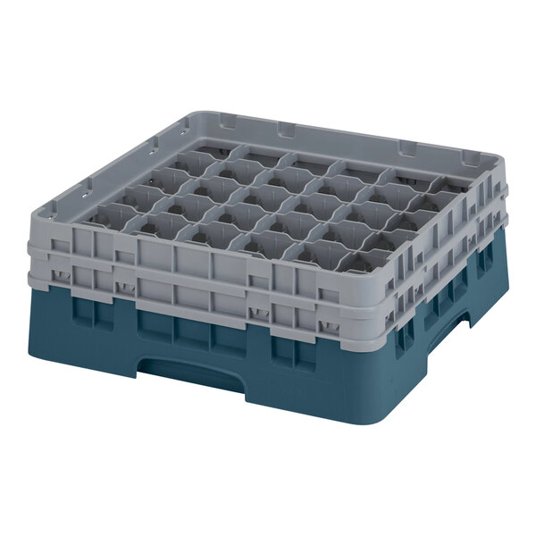A teal plastic container with many compartments and holes.