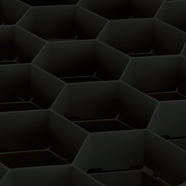 A close up of a black hexagonal grid with a white object on top.